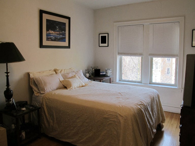 a bedroom with a bed and a window