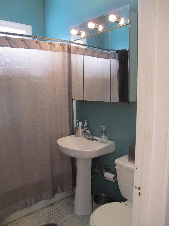 a bathroom with a sink and a mirror and a toilet