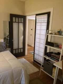 a bedroom with a bed and a sliding glass door