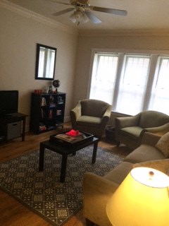 a living room with a couch and chairs and a coffee table