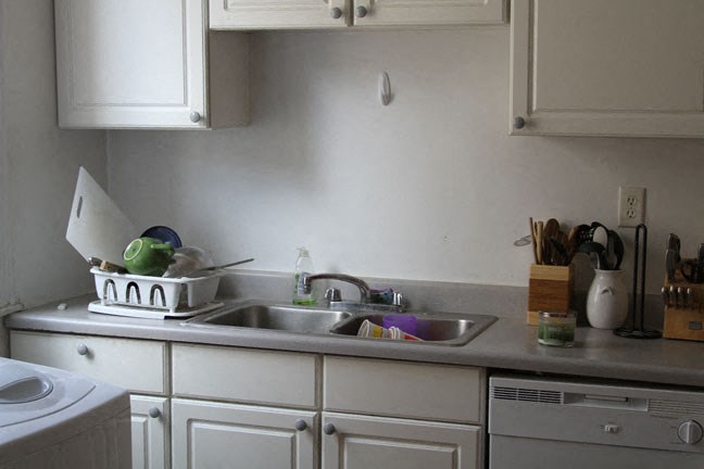 a kitchen with a sink and some white cabinets