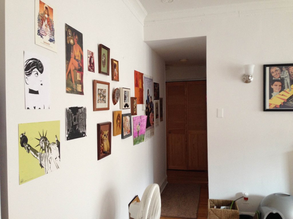 the wall in my living room is full of art