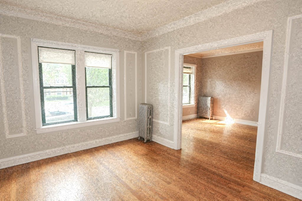 an empty living room with a wood floor and a window