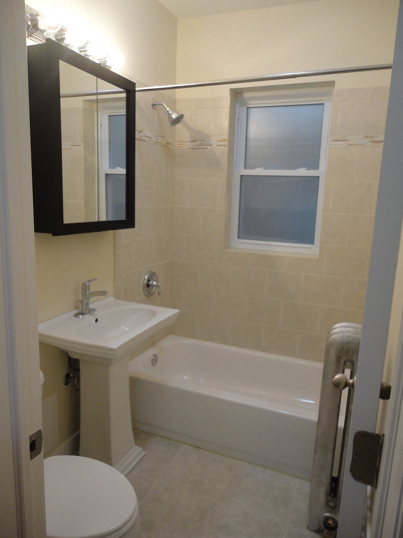 a small bathroom with a sink and a bath tub