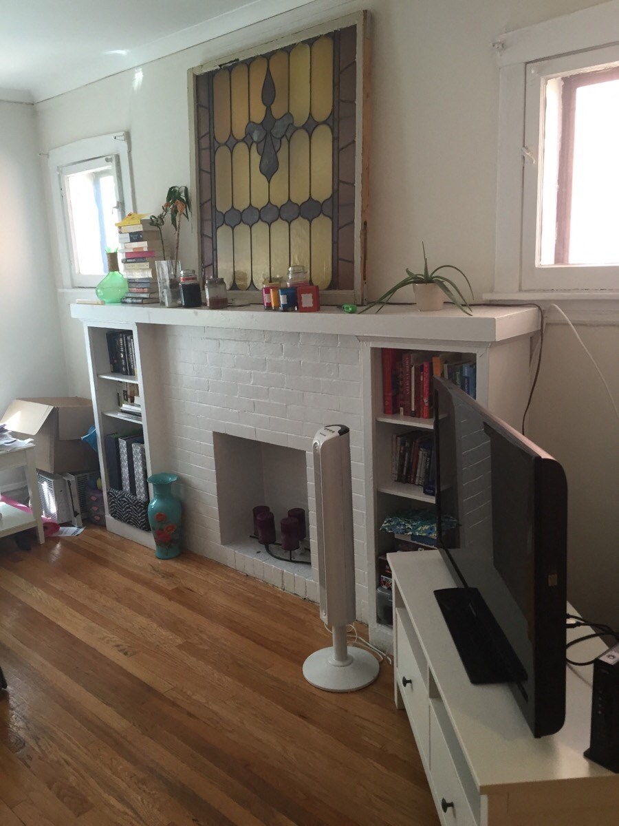 a living room with a fireplace and a television