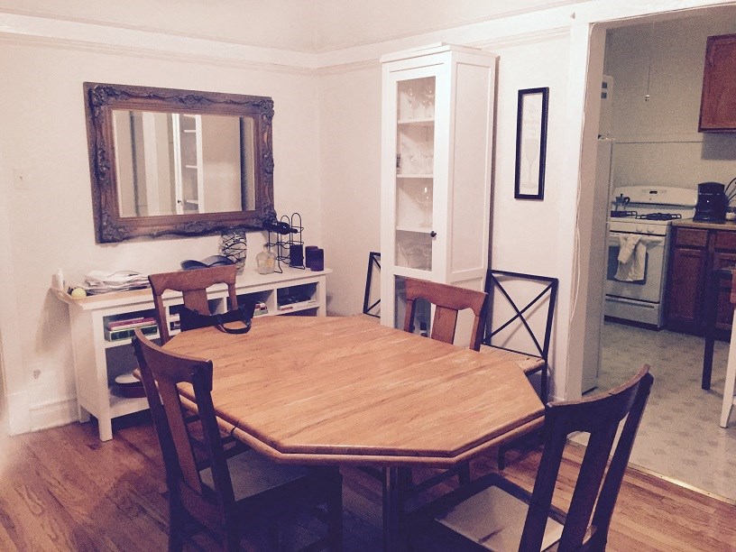 a dining room with a wooden table and chairs