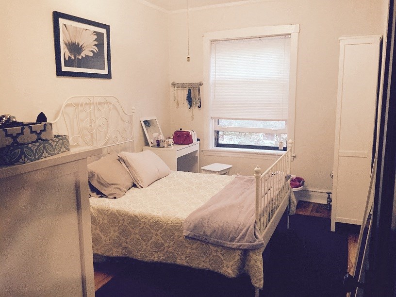 a small bedroom with a bed and a window