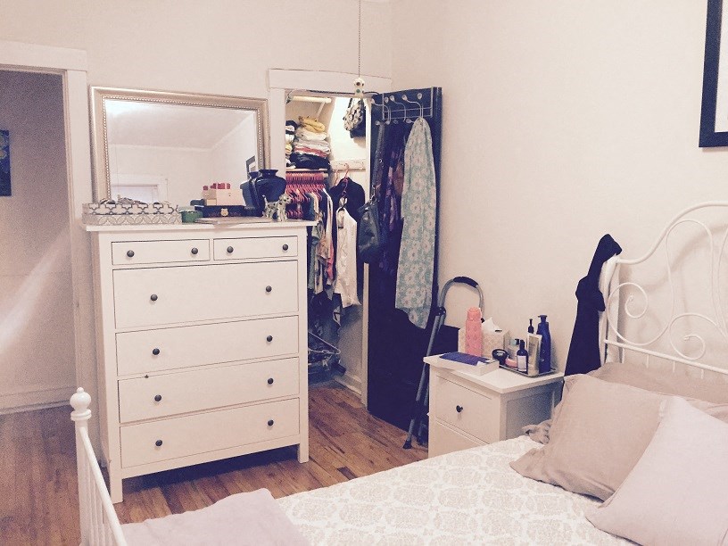 a bedroom with a dresser and a closet