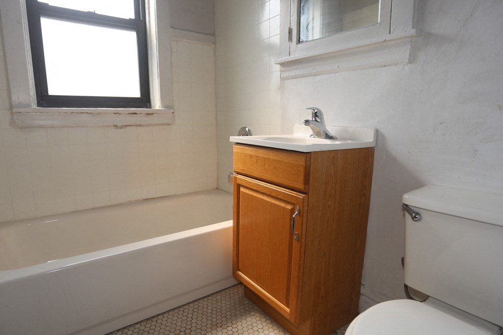 an empty bathroom with a sink toilet and bath tub