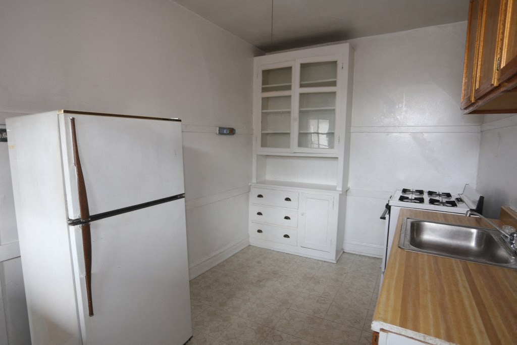 a kitchen with a refrigerator and a sink