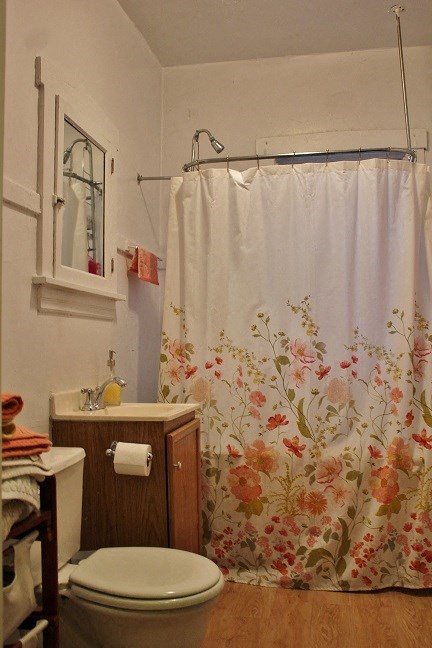 a bathroom with a shower curtain and a toilet