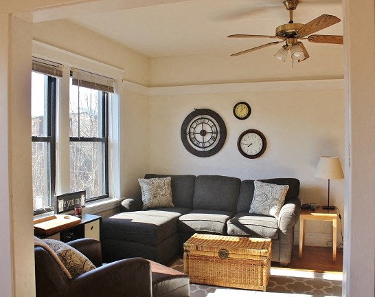 a living room with a couch and a ceiling fan