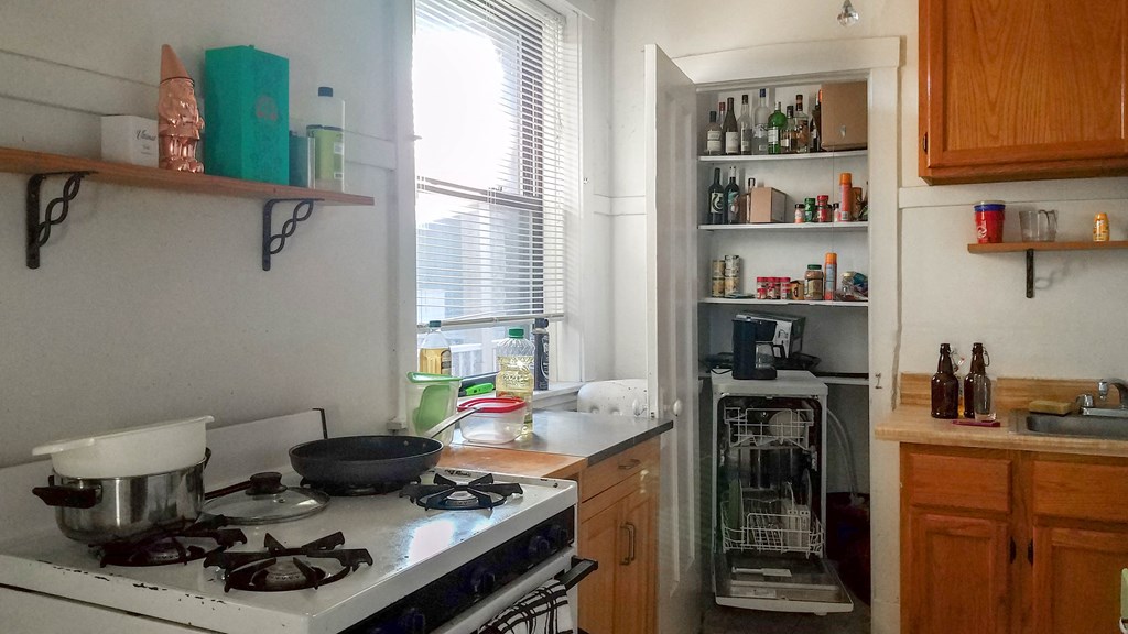 a small kitchen with a stove and a window