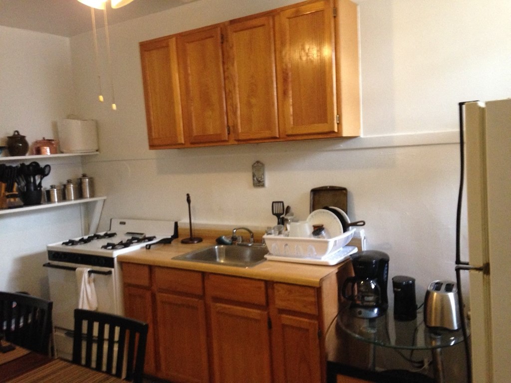 a small kitchen with a sink and a refrigerator