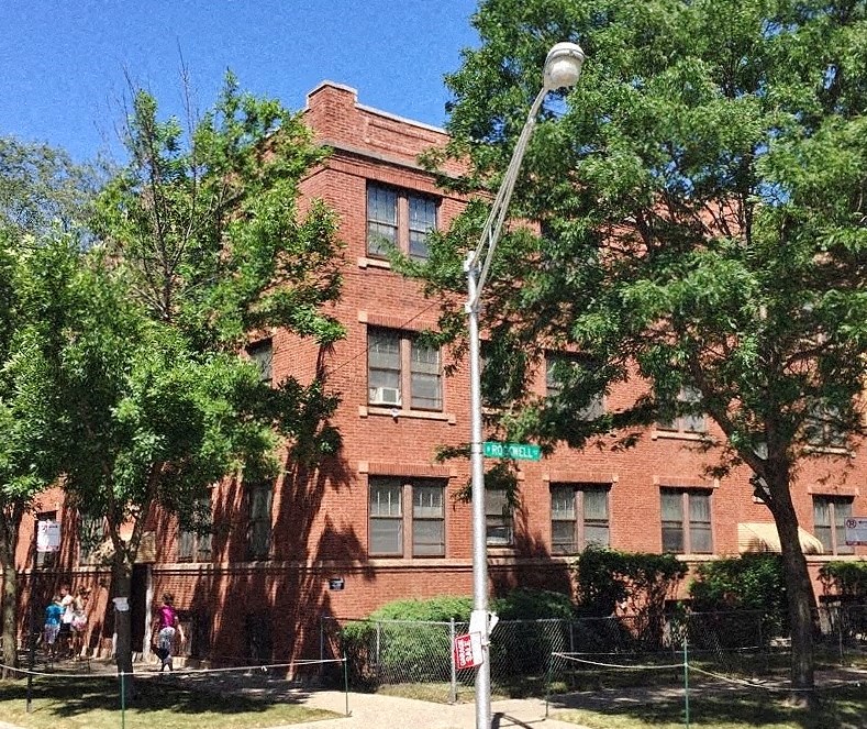 a brick building with a street light in front of it
