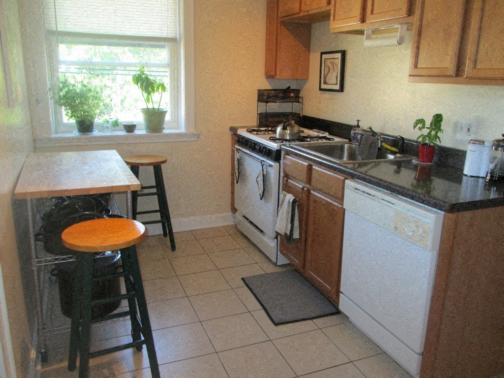 a kitchen with a stove top oven and a sink