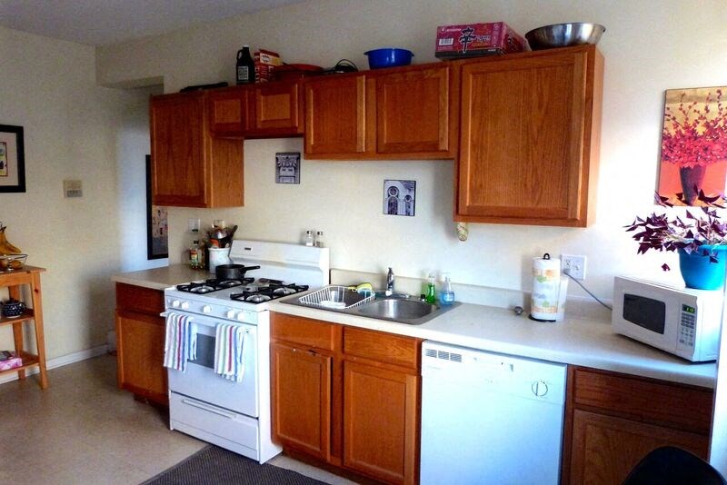 a kitchen with white appliances and wooden cabinets
