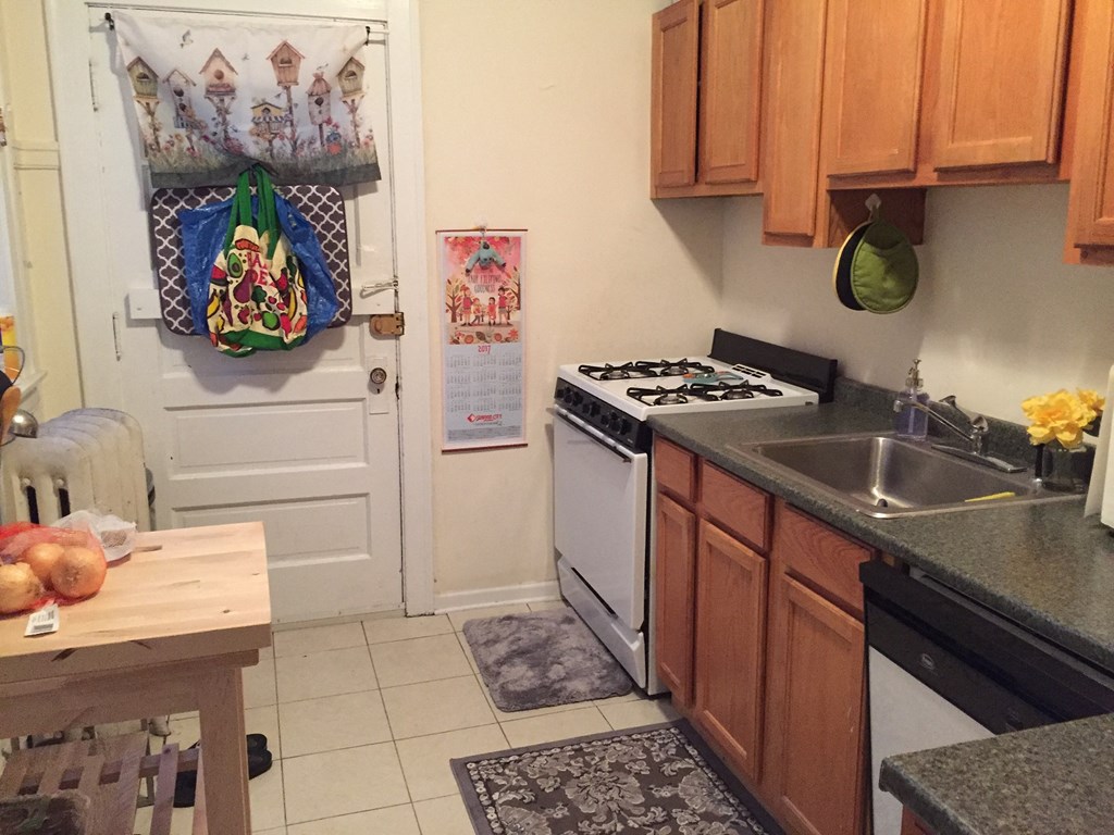 a small kitchen with a stove and a sink