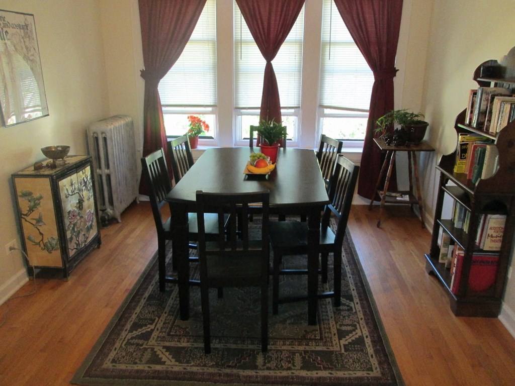 a dining room with a black table and chairs
