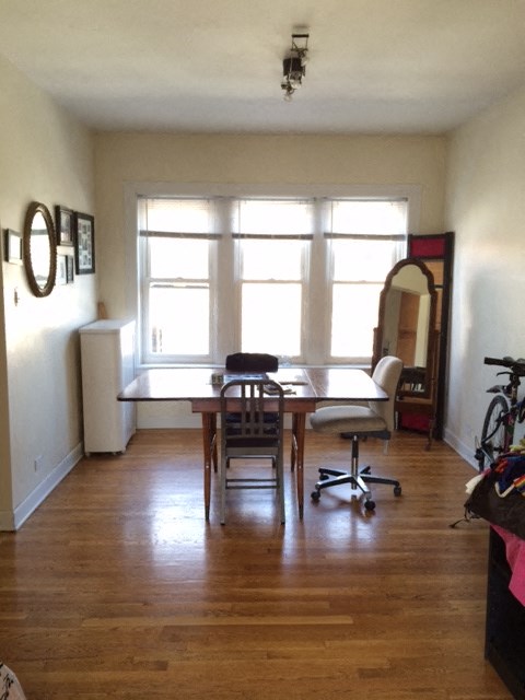 an empty living room with a table and a window