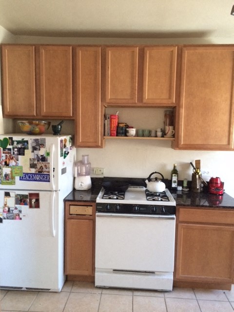 a kitchen with a stove and a refrigerator