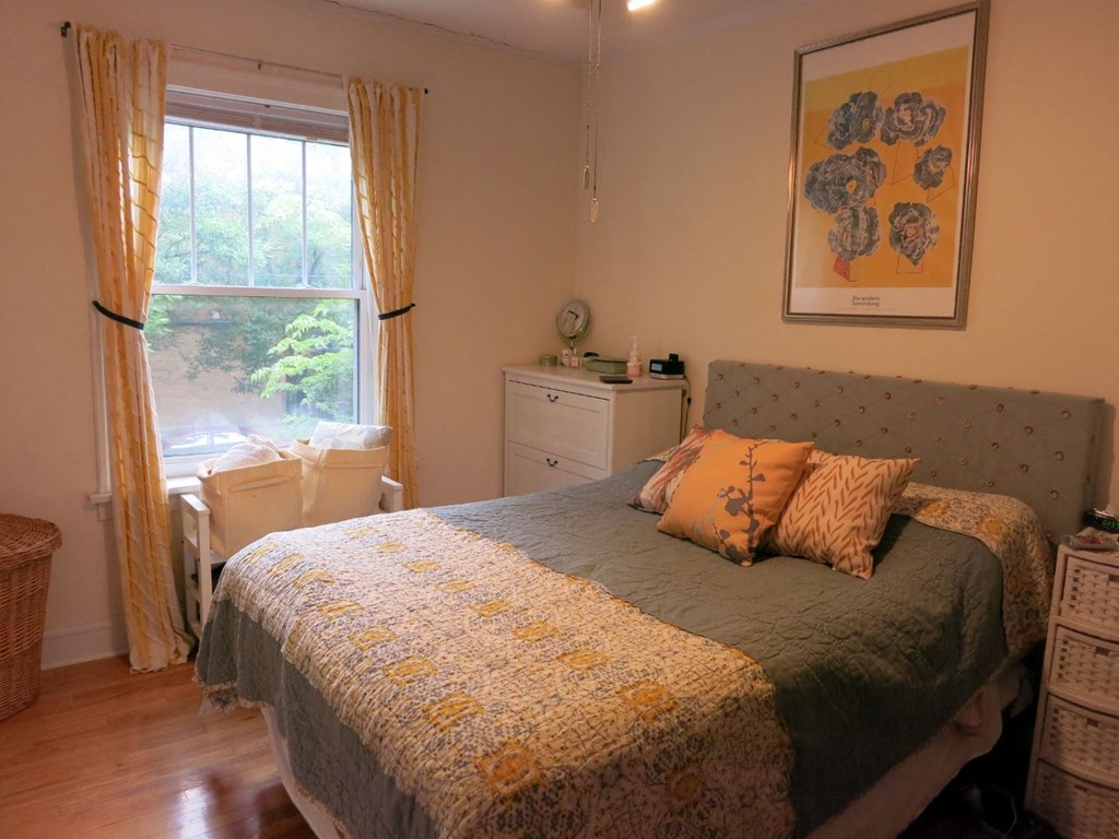 a bedroom with a bed and a window