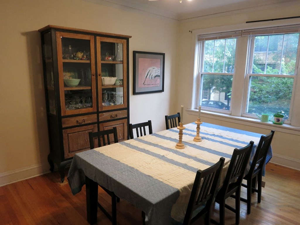 a dining room with a table and chairs and a cabinet