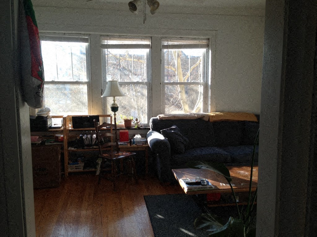 a living room with a couch and a window