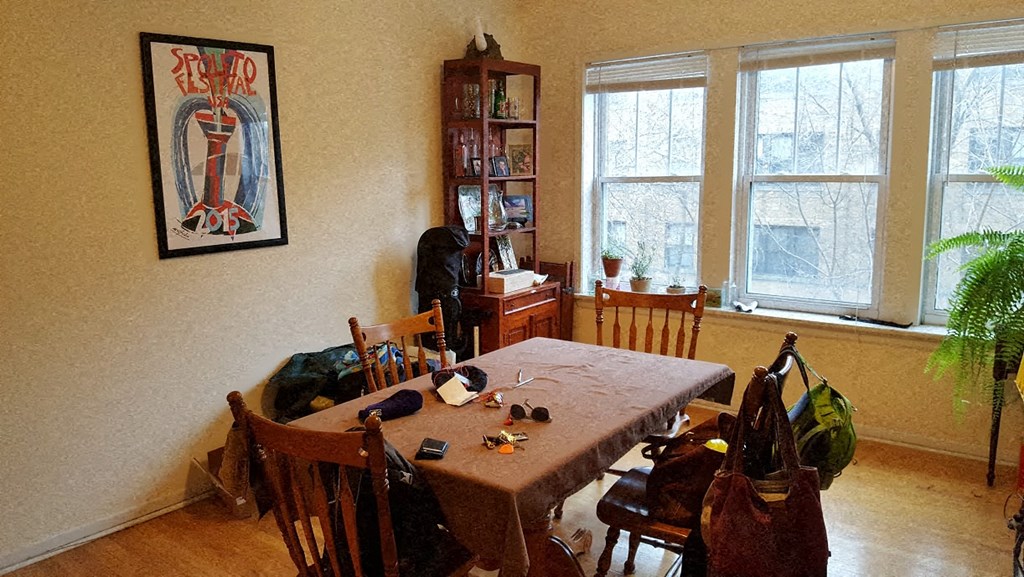 a dining room with a wooden table and chairs