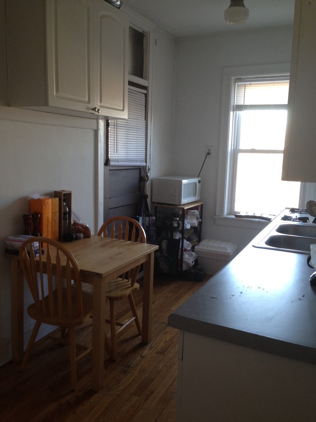 a kitchen with a table and chairs and a sink