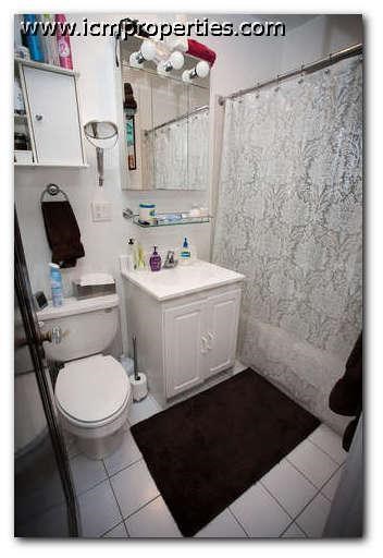 a bathroom with a toilet and a sink and a shower