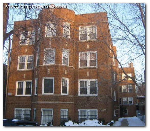 a red brick building with snow in front of it