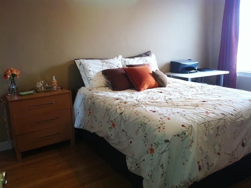 a bedroom with a bed with two pillows on it