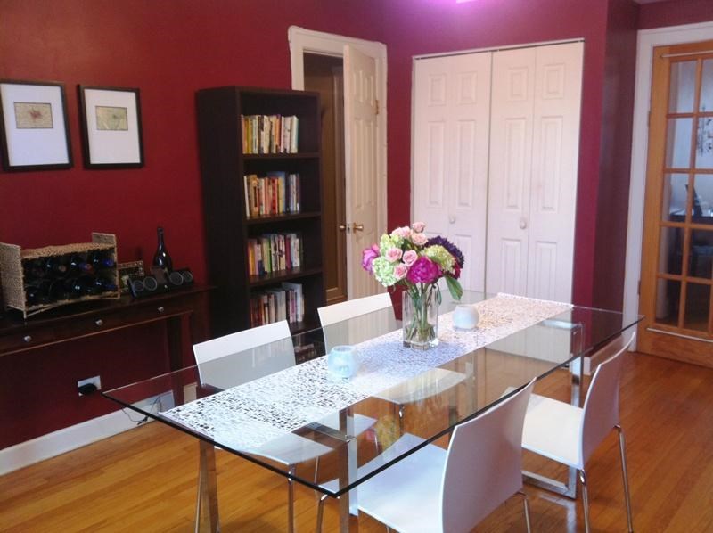 a dining room with a glass table and white chairs