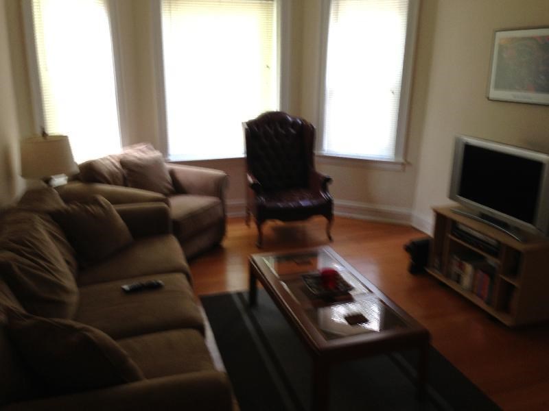 a living room with a couch and a chair and a television