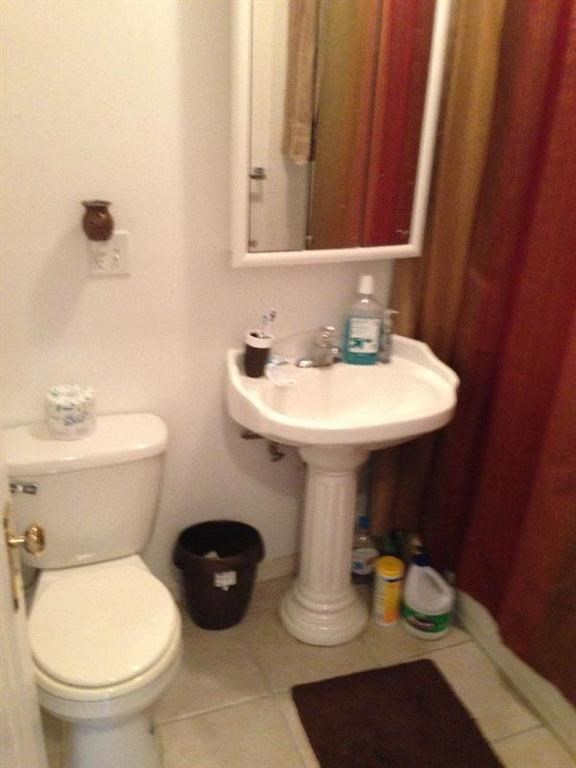 a bathroom with a toilet and a sink and a mirror