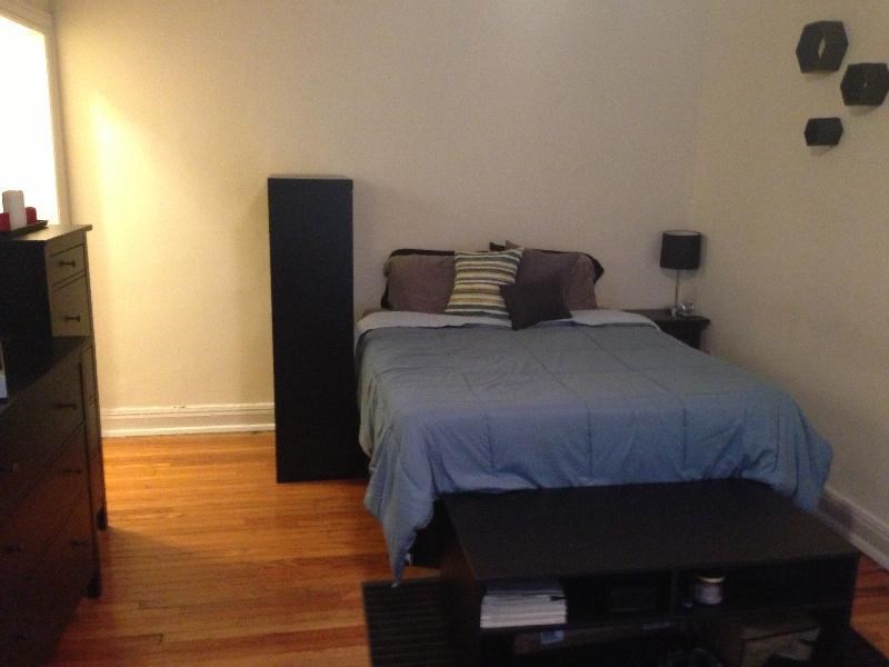 a bedroom with a bed and a black dresser