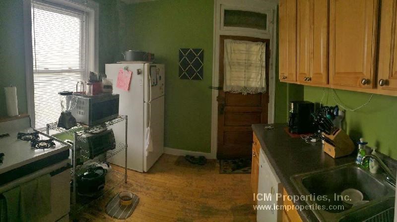 a kitchen with a refrigerator and a sink