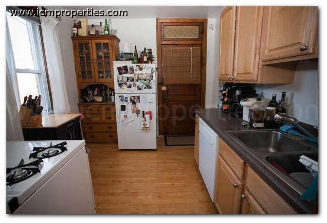 a kitchen with a stove and a refrigerator