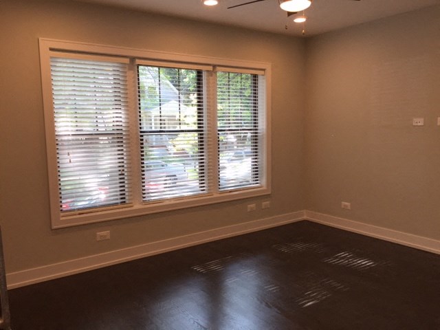 a living room with a large window with blinds