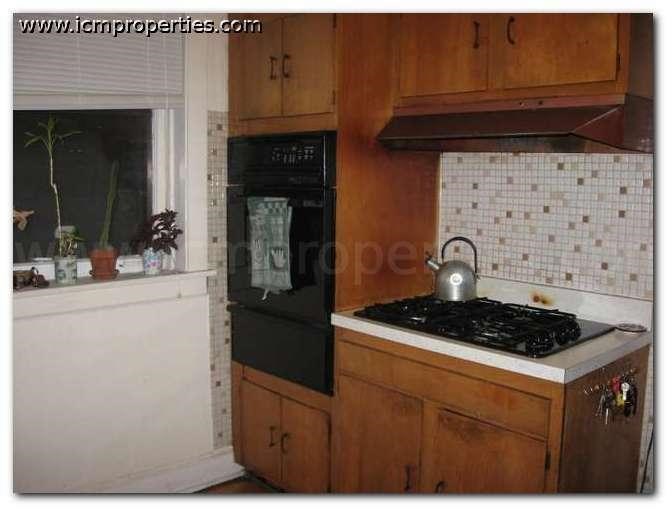 a kitchen with a stove and a black oven