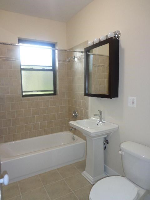 a bathroom with a sink toilet and a bath tub