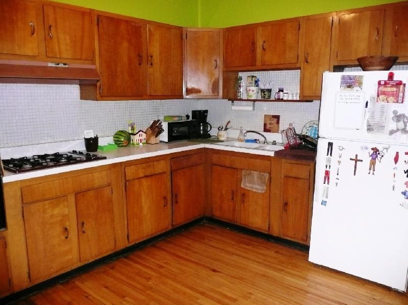 a kitchen with wooden cabinets and a white refrigerator