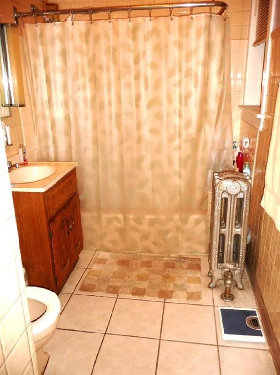 a bathroom with a shower curtain and a toilet
