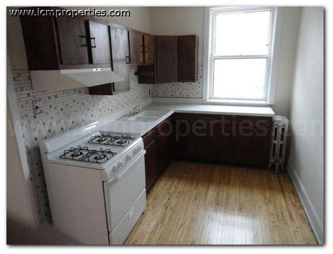 a small kitchen with a stove and a window