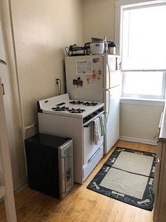 a small kitchen with a stove and a refrigerator