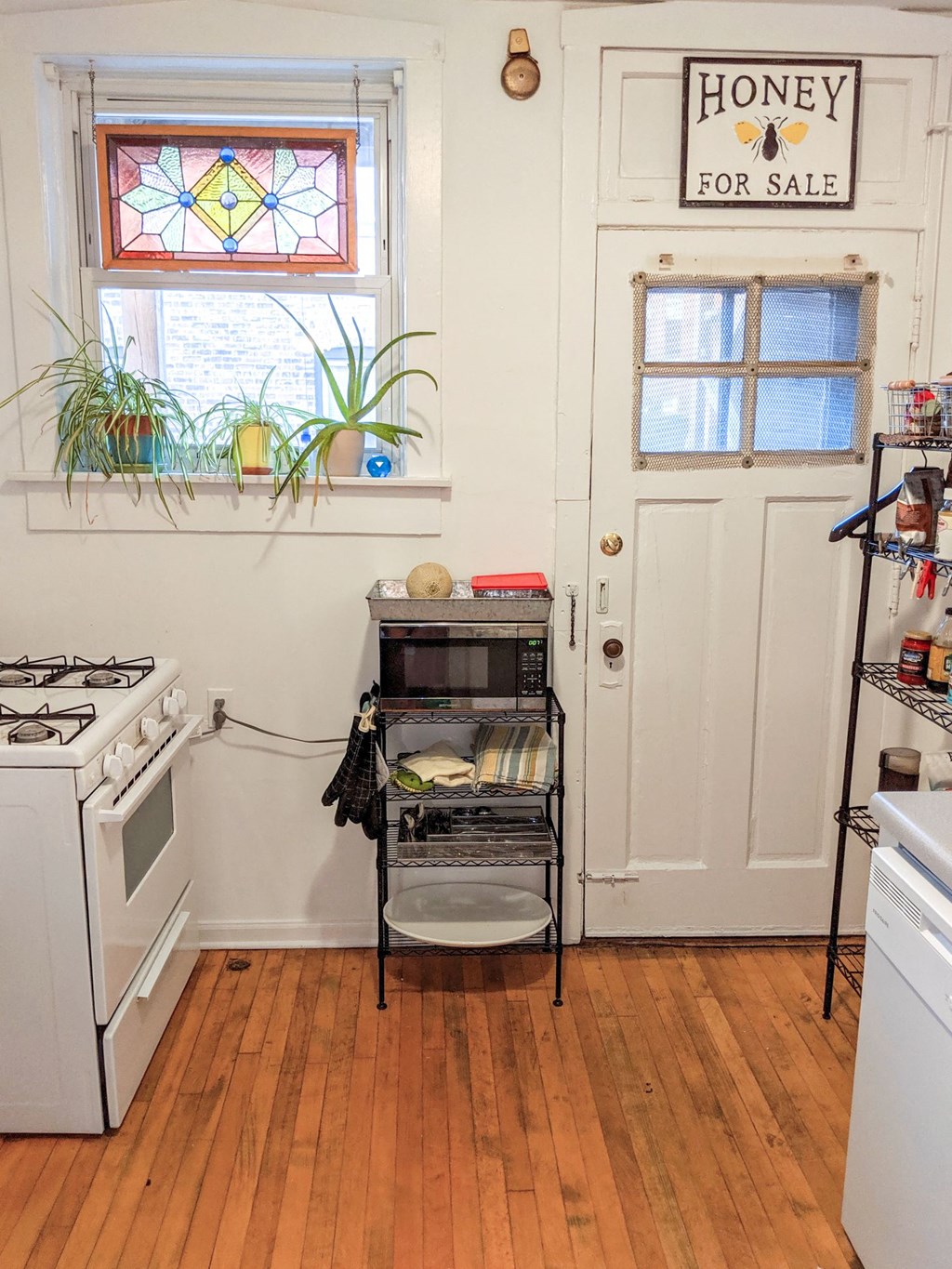a small kitchen with a stove and a door