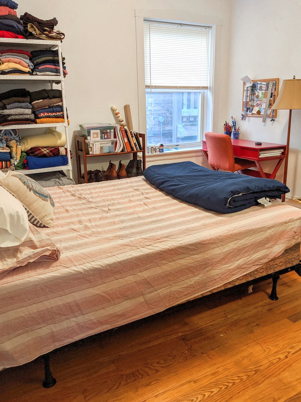 a bedroom with a bed and a closet and a window