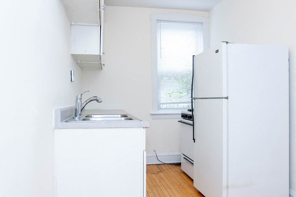 a small kitchen with a refrigerator and a sink