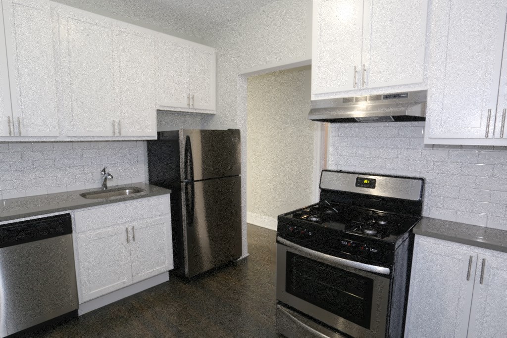 an empty kitchen with a stove refrigerator and sink